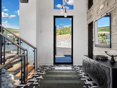 Modern entryway with mountain views welcomes you home. Light-filled, open architecture features bold tile, contemporary details, and a seamless connection to scenic outdoor spaces.