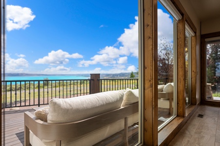Open your glass doors to an incredible view—brilliant turquoise waters stretch out before your private balcony, where relaxation and natural beauty meet.