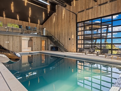 Step into your private indoor pool oasis, where soaring ceilings, modern design, and floor-to-ceiling windows create a luxurious space for relaxation and rejuvenation.