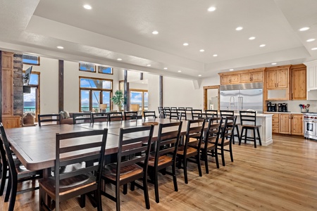 Gather with your group around this expansive dining table that seats everyone comfortably. Natural light floods through tall windows, while the open kitchen invites easy conversation and meal prep together.