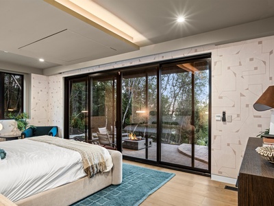 Wake to your private sanctuary with floor-to-ceiling doors opening to a tranquil patio and firepit. Sink into your plush bed and imagine mornings filled with fresh air.
