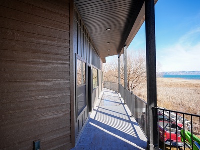Stunning mountain and lake vistas stretch before this covered balcony, where crisp air and breathtaking scenery create the perfect outdoor retreat.