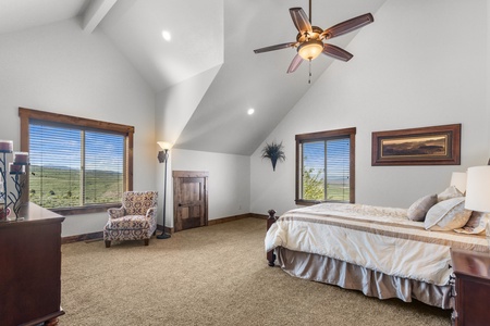 Averon Lodge - Bear Lake Luxury Rentals. Wake up to sweeping countryside views in your spacious bedroom, where vaulted ceilings and gentle ceiling fan breezes create the perfect retreat.