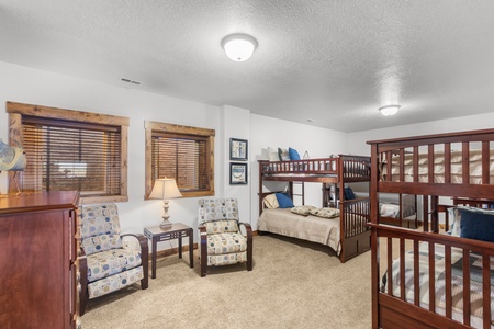 Averon Lodge - Bear Lake Luxury Rentals. You'll love this cozy bedroom with comfortable bunk beds and a perfect seating area for reading or relaxing together.