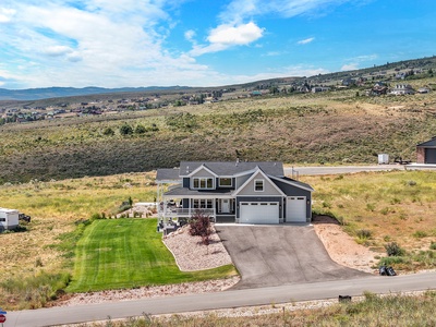 Stunning modern home nestled in Utah's scenic landscape with mountain views and spacious outdoor areas.