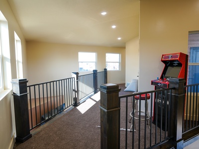 Challenge your friends to classic arcade games in this bright upper-level gaming loft, complete with retro arcade machine and high-top seating.