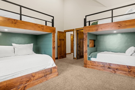 Your group will love these cozy built-in bunk nooks with plush bedding and charming wood accents. Natural light fills the room while everyone enjoys their own private sleeping space.