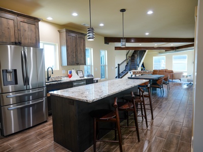 Your spacious kitchen features granite countertops, stainless steel appliances, and a breakfast bar where you can gather with loved ones.