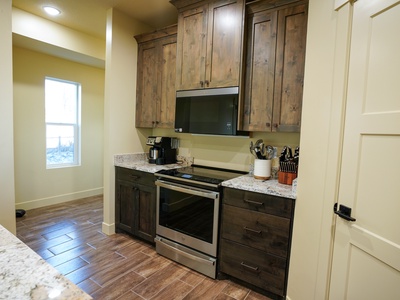 Your fully equipped kitchen features rustic cabinetry, granite counters, and everything you need to prepare delicious meals together.