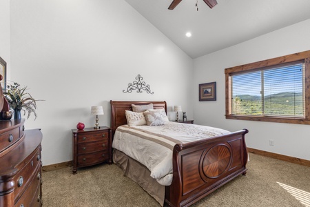 Averon Lodge - Bear Lake Luxury Rentals. Relax in your elegant bedroom with rich wood furnishings and stunning mountain views stretching to the horizon through your private window.