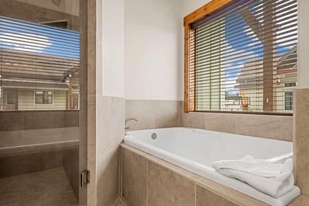 Soak away the day in your deep soaking tub, with fresh towels and natural light streaming through the window—pure relaxation awaits.