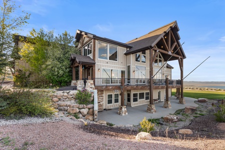 Averon Lodge - Bear Lake Luxury Rentals-Stunning rustic-modern retreat with expansive timber frame architecture, nestled among mature trees and natural stone landscaping in a peaceful country setting.