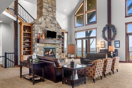 Averon Lodge - Bear Lake Luxury Rentals. Settle into this stunning living room where soaring ceilings and a crackling stone fireplace create the perfect mountain retreat atmosphere.