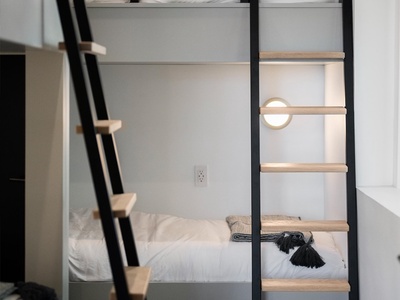 Rest easy in your cozy bunk space, complete with fresh linens, a personal reading light, and clever ladder access. Your own little retreat awaits.
