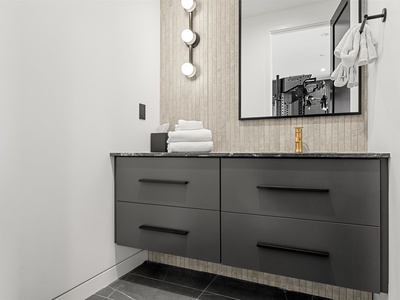 Refresh in your sleek, modern bathroom with chic vanity lighting, plush towels, and stylish accents that set the perfect tone for your getaway.