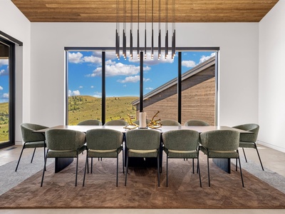 Gather around this stunning dining table where meals become unforgettable moments, framed by sweeping views of rolling hills and wide-open skies.