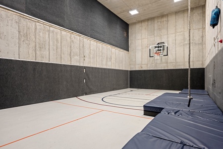 This private indoor sports court is ready for action—shoot hoops, climb the rope, or challenge friends to a game in your own climate-controlled athletic space.