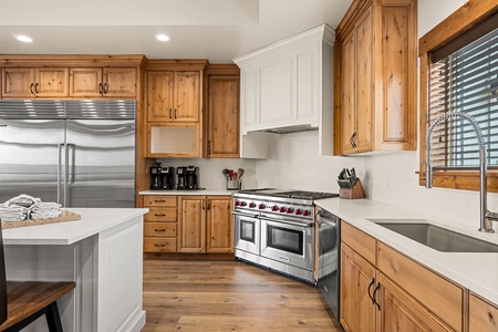 Your gourmet kitchen awaits, with gleaming stainless appliances and warm wood cabinetry creating the perfect space to whip up memorable meals during your stay.