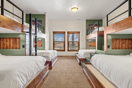 Your group will love this custom bunk room with four sturdy beds, crisp linens, and plenty of cozy space for everyone to sleep soundly.