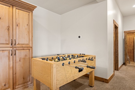 Challenge your friends to a friendly match at the foosball table in this bright, carpeted game space—perfect for downtime between mountain adventures.