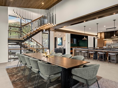 Gather around a stunning dining table beneath sculptural lighting, with sweeping mountain views and a chef's kitchen ready for your culinary adventures.