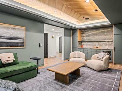 Sink into plush seating beneath stunning wood ceilings in your stylish living space, where contemporary design meets cozy comfort for ultimate relaxation.