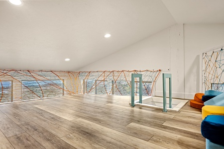 Your private loft space with whimsical rope netting creates a fun hideaway for kids or a cozy reading nook. The bright, open design invites playful moments and relaxation.