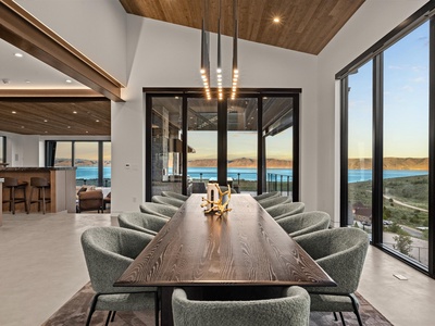 Step into your elegant dining space with stunning lake views framing every meal. Modern wood touches and floor-to-ceiling windows bring the outdoors in, creating the perfect backdrop for gathering.