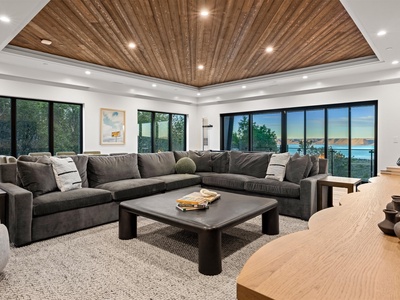 Sink into plush seating beneath striking wood ceilings while lake views frame your perfect escape. This inviting lounge is designed for your relaxation and unforgettable moments.