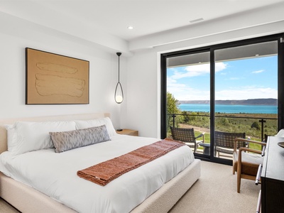 Wake to stunning ocean views through your sliding glass doors—this bright, serene bedroom with balcony access invites peaceful mornings and tranquil evenings by the sea.