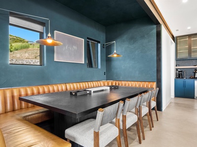 Gather around this stunning dining table with plush leather banquette seating and elegant pendant lighting. Your group meals will feel like special occasions in this sophisticated space.
