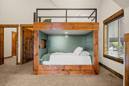 Your group will love this cozy bunk nook, where solid wood construction meets calming sage tones. Climb up to the loft bed above, or settle into the inviting lower bunk—both thoughtfully designed for restful mountain nights.
