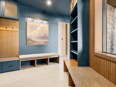 Beautifully designed entry space with custom millwork, built-in seating with storage, and serene artwork creating a welcoming arrival to your vacation home.