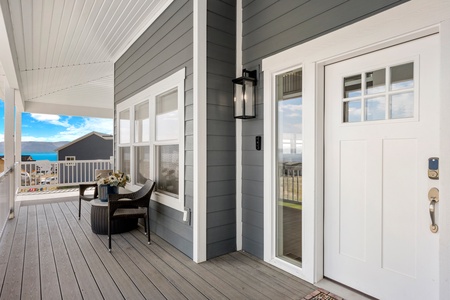 Step onto your private covered porch with ocean views and outdoor seating - the perfect spot to start your morning with coffee.