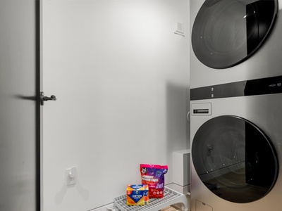 Convenient stacked washer and dryer in your private laundry area, with complimentary detergent pods ready for you.