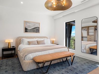 Sink into this plush bed and enjoy serene views through the window. The warm lighting and thoughtful design create a peaceful retreat for your perfect escape.