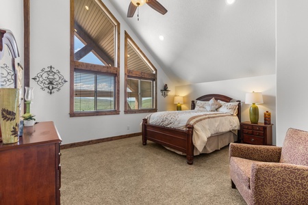 Averon Lodge - Bear Lake Luxury Rentals. Rest peacefully in your spacious loft bedroom featuring soaring vaulted ceilings, warm wood accents, and comfortable seating for relaxation.