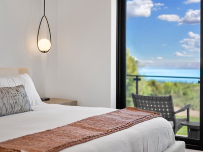 Wake up to stunning lake and garden views from your bright, modern bedroom. Crisp linens and thoughtful design invite you to unwind while nature's beauty surrounds you.