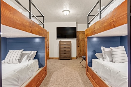 Your group will love this smart bunk room—four cozy beds with crisp linens, plenty of storage, and your own TV for late-night movies or morning cartoons.