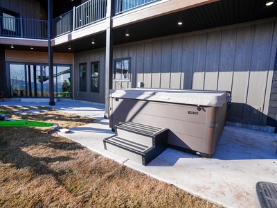 Soak under sunny skies in your private hot tub, perfectly positioned for ultimate relaxation right outside your door.