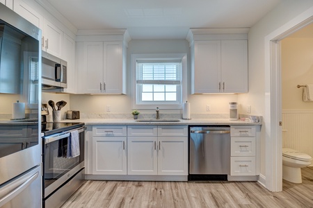Your bright, fully-equipped kitchen features granite counters, stainless steel appliances, and everything you need to prepare delicious meals during your stay.