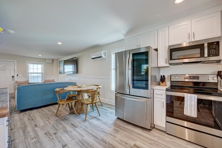 Your modern kitchen awaits with gleaming stainless appliances, ample cabinet storage, and a cozy dining nook perfect for morning coffee or evening meals together.