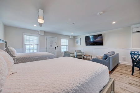 Your spacious room features two comfortable beds plus a cozy seating area where you can unwind while watching TV.
