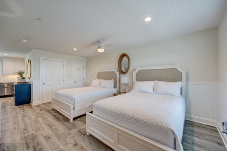 Your spacious room features two comfortable queen beds with crisp white linens, perfect for families or friends sharing.