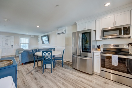 Your fully equipped kitchen features stainless steel appliances, white cabinetry, and open dining area perfect for home-cooked meals together.