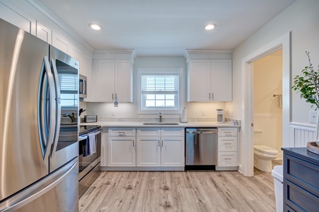 Your bright, fully-equipped kitchen features modern stainless appliances and ample counter space for preparing meals during your stay.