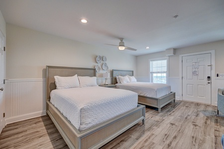 Your spacious bedroom features two plush beds with crisp linens, creating the perfect retreat for rest and relaxation.