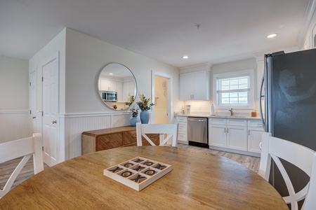 Your bright open kitchen invites memorable meals with modern appliances and charming coastal details perfectly arranged for your comfort.