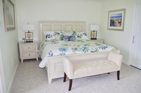The Primary bedroom has a flat panel tv, custom cabinetry, en-suite bath and lanai access.