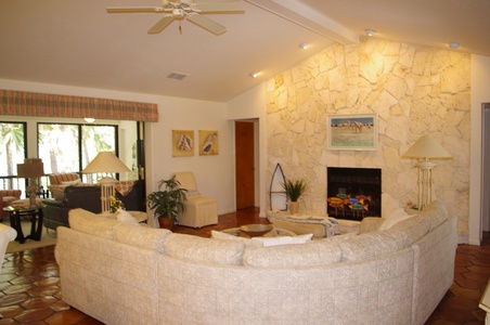 The living room has a beautiful coquina fireplace feature wall.